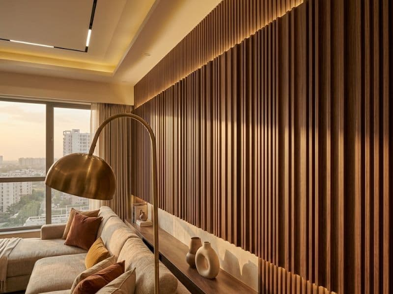 Fluted wood wall panels in a Noida apartment bedroom feature wall